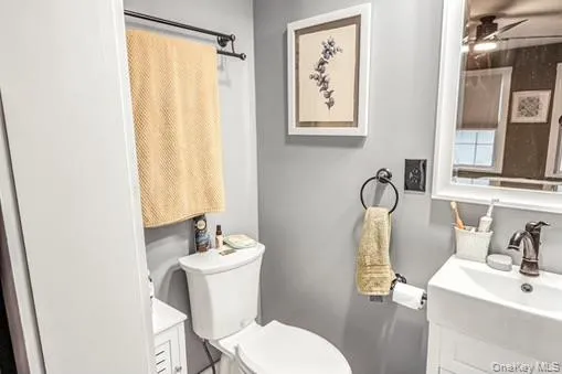 Half bathroom featuring vanity and ceiling fan Half bathroom featuring vanity and ceiling fan
