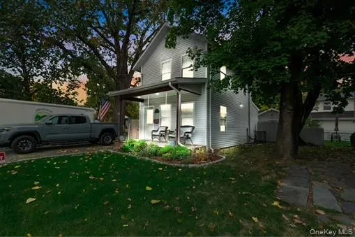 View of home's exterior with a yard and covered porch View of home's exterior with a yard and covered porch