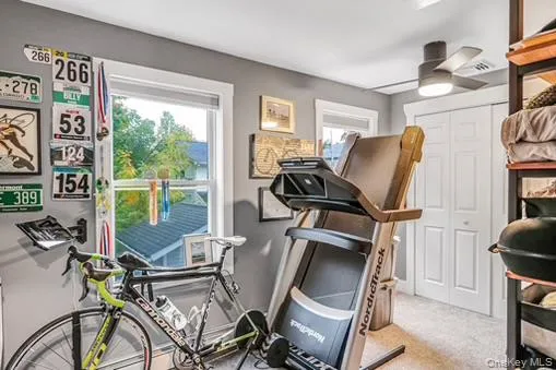 Exercise area with light carpet and ceiling fan Exercise area with light carpet and ceiling fan