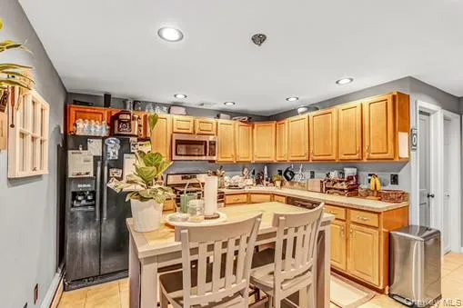 Kitchen featuring light countertops, stainless steel appliances, light tile patterned flooring, and recessed lighting Kitchen featuring light countertops, stainless steel appliances, light tile patterned flooring, and recessed lighting
