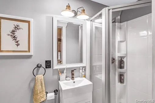 Full bathroom featuring a stall shower and vanity Full bathroom featuring a stall shower and vanity