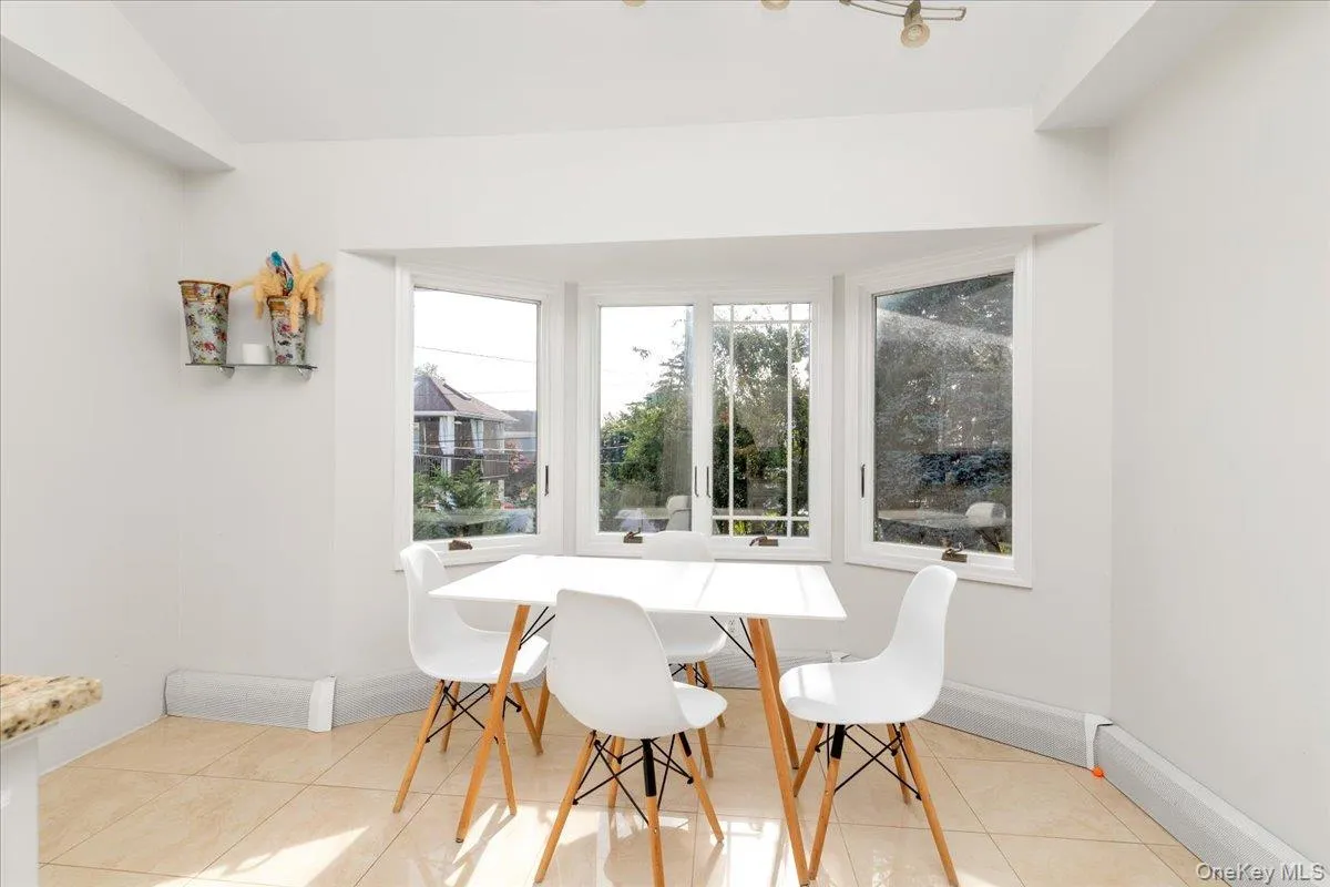 Dining room with light tile patterned flooring and baseboards Dining room with light tile patterned flooring and baseboards