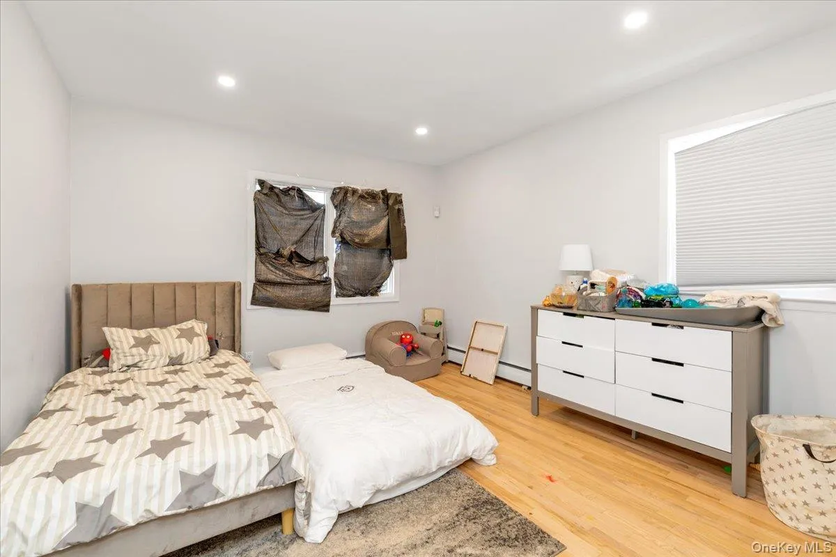 Bedroom with light wood finished floors and recessed lighting Bedroom with light wood finished floors and recessed lighting