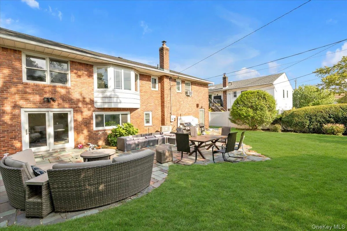 Rear view of property with outdoor lounge area, a patio area, and brick siding Rear view of property with outdoor lounge area, a patio area, and brick siding