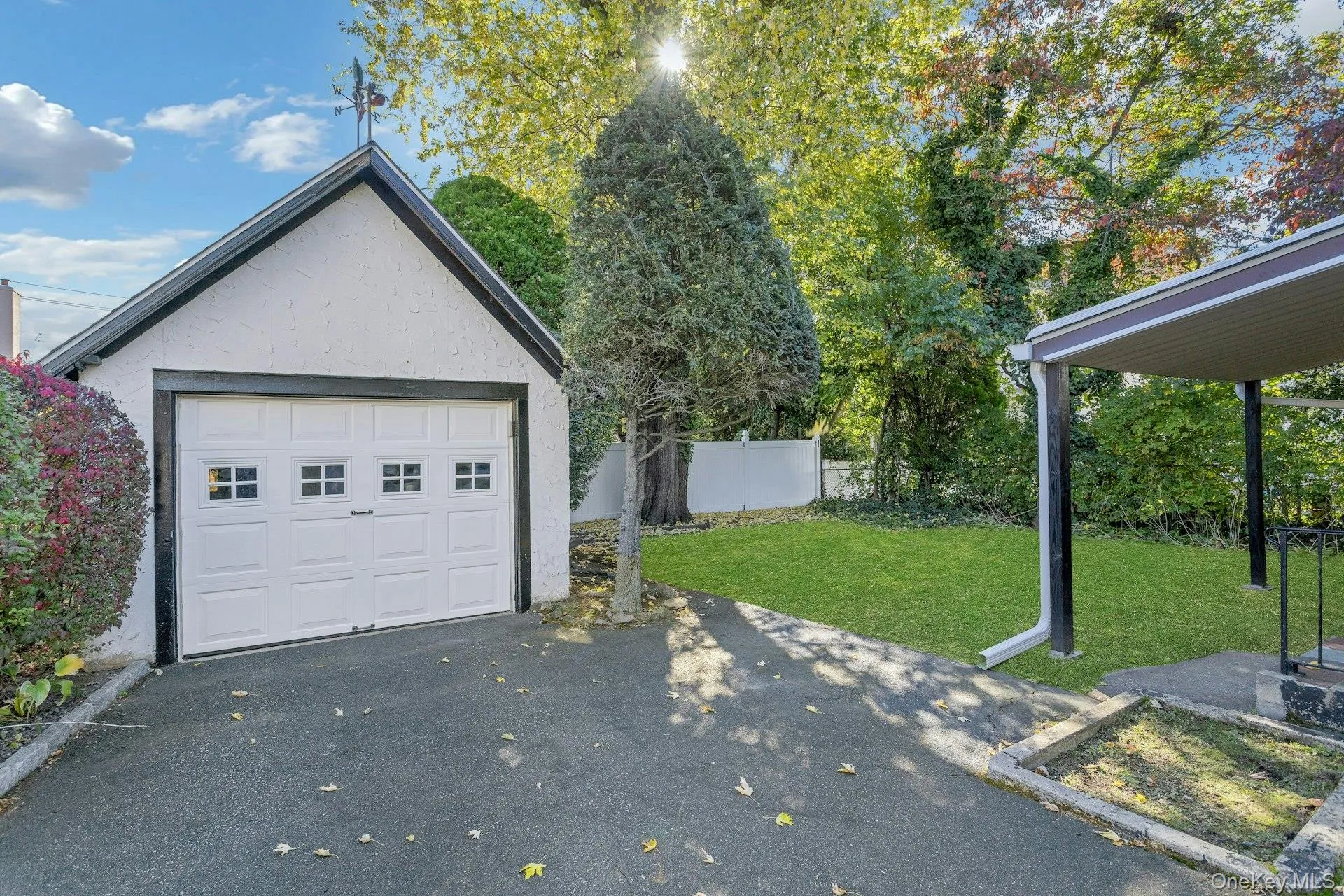 Detached garage with asphalt driveway Detached garage with asphalt driveway