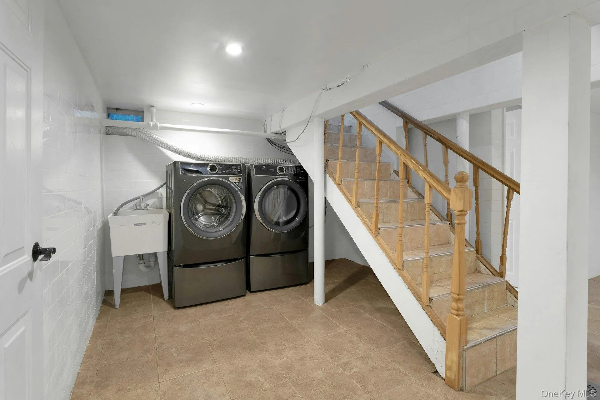 Washroom with washer and clothes dryer Washroom with washer and clothes dryer