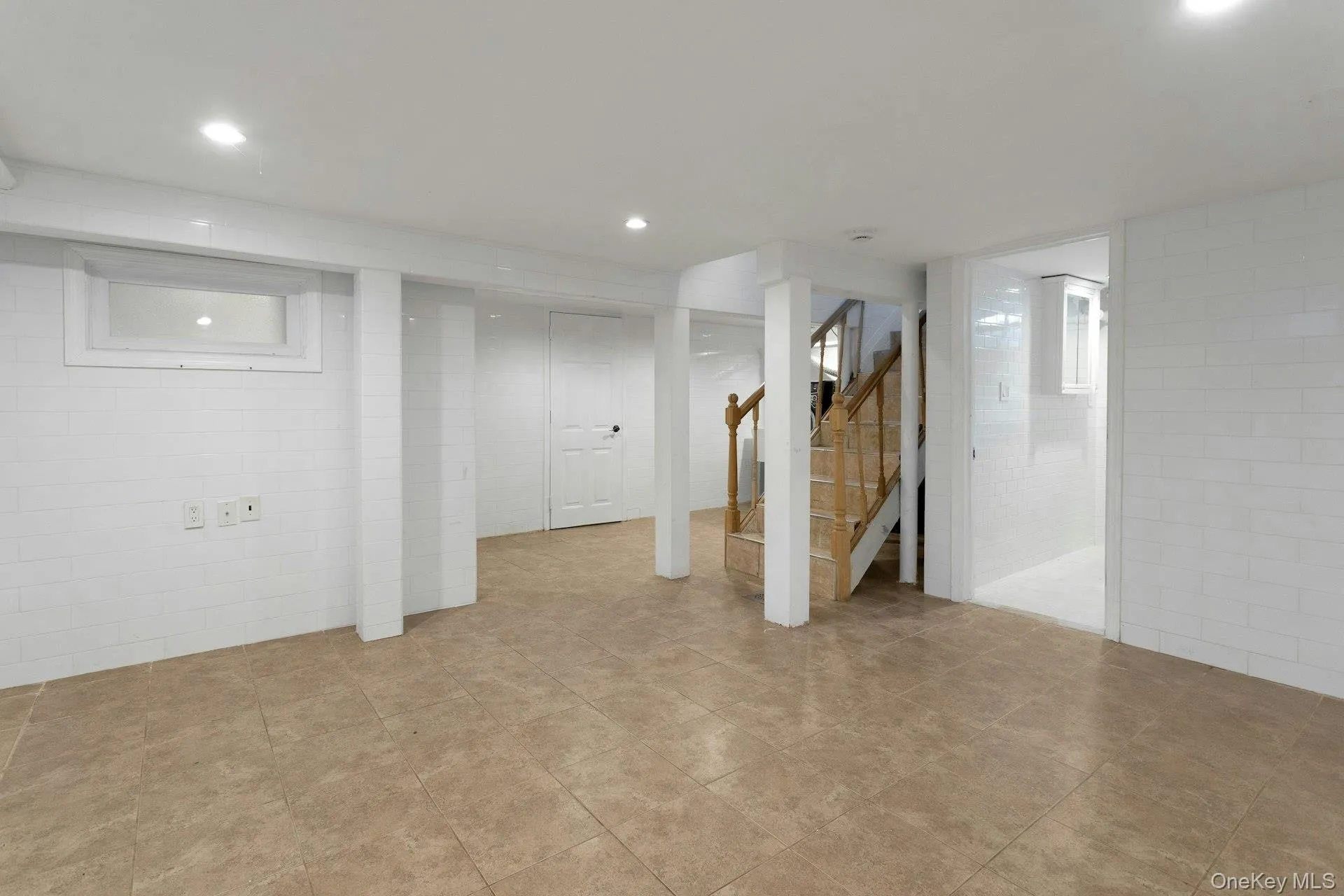 Finished below grade area with stairs and recessed lighting Finished below grade area with stairs and recessed lighting