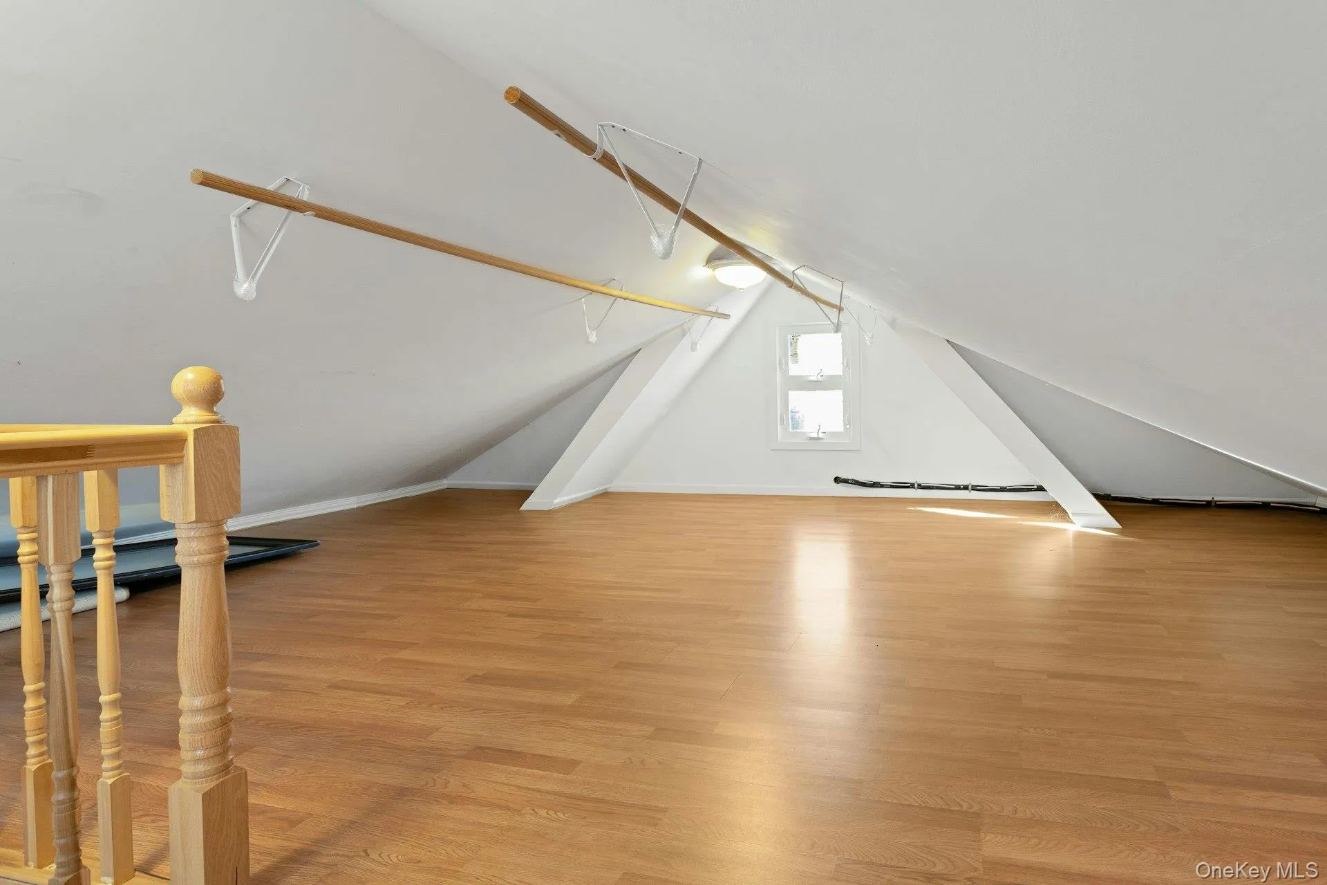Bonus room featuring light wood-style floors and lofted ceiling Bonus room featuring light wood-style floors and lofted ceiling