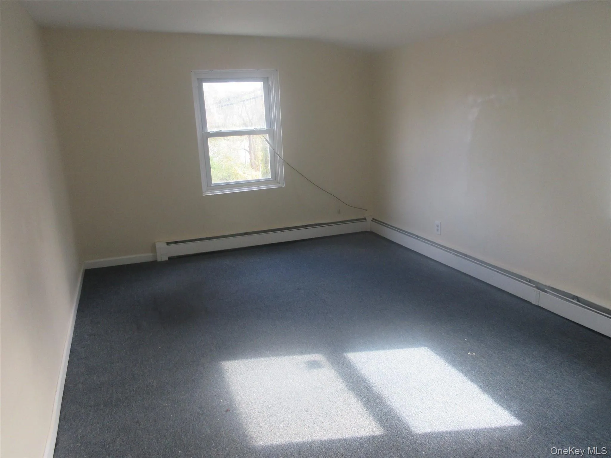 Empty room featuring baseboards and baseboard heating Empty room featuring baseboards and baseboard heating