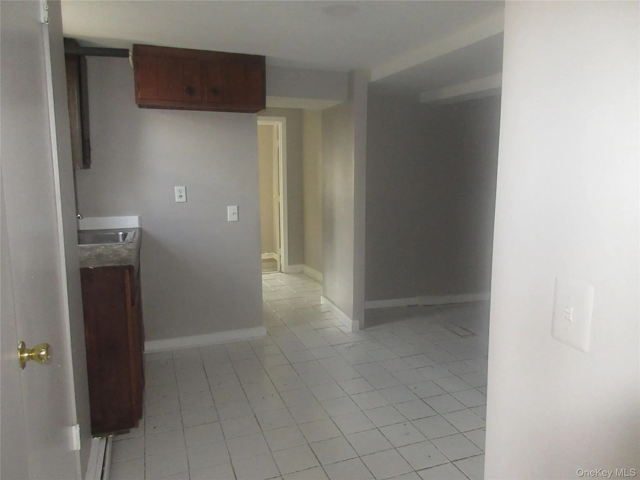 Hall featuring light tile patterned floors Hall featuring light tile patterned floors