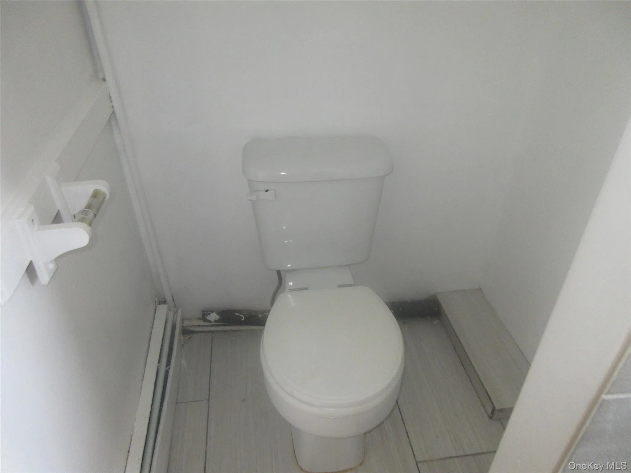 Bathroom with toilet and baseboard heating Bathroom with toilet and baseboard heating