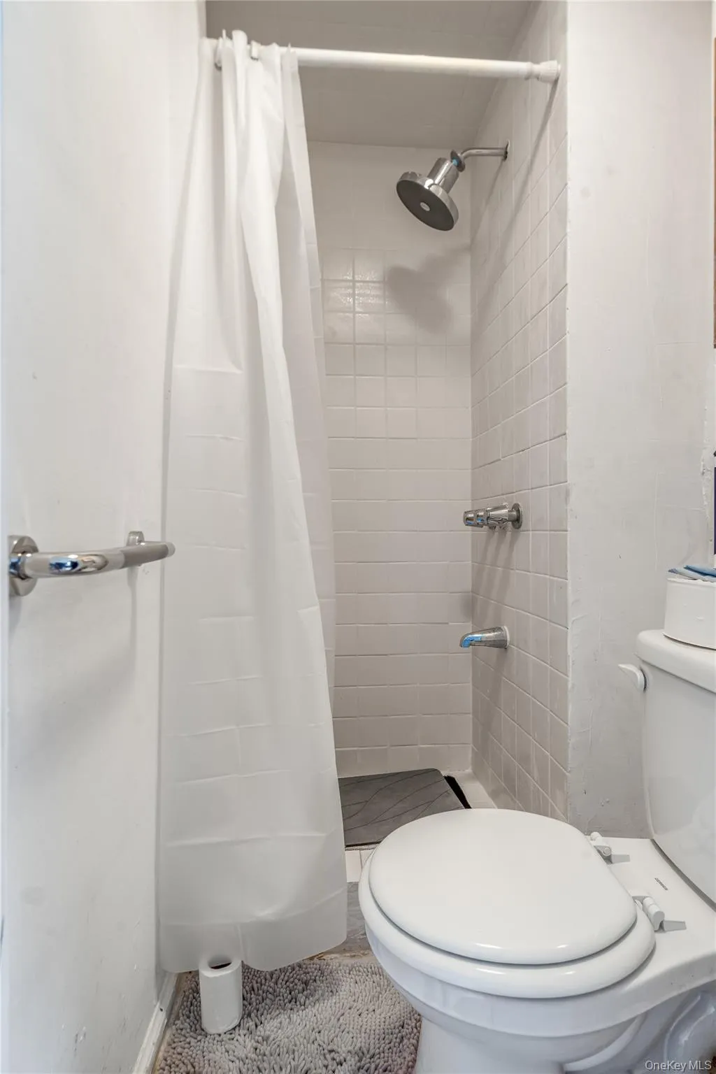 Full bathroom featuring a stall shower Full bathroom featuring a stall shower