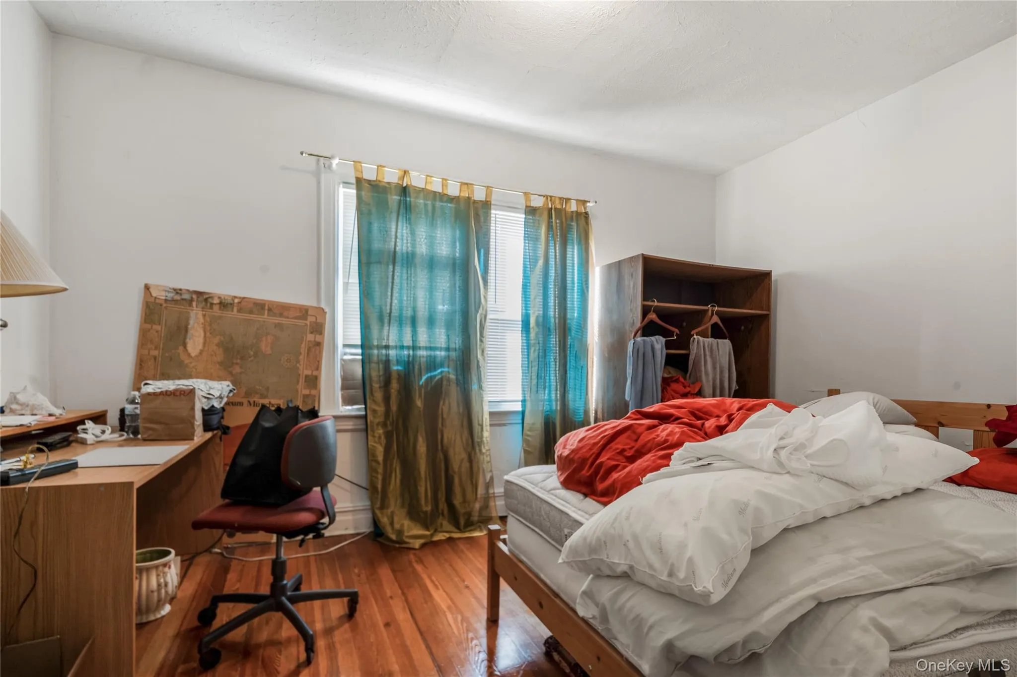 Bedroom with wood-type flooring and a desk Bedroom with wood-type flooring and a desk