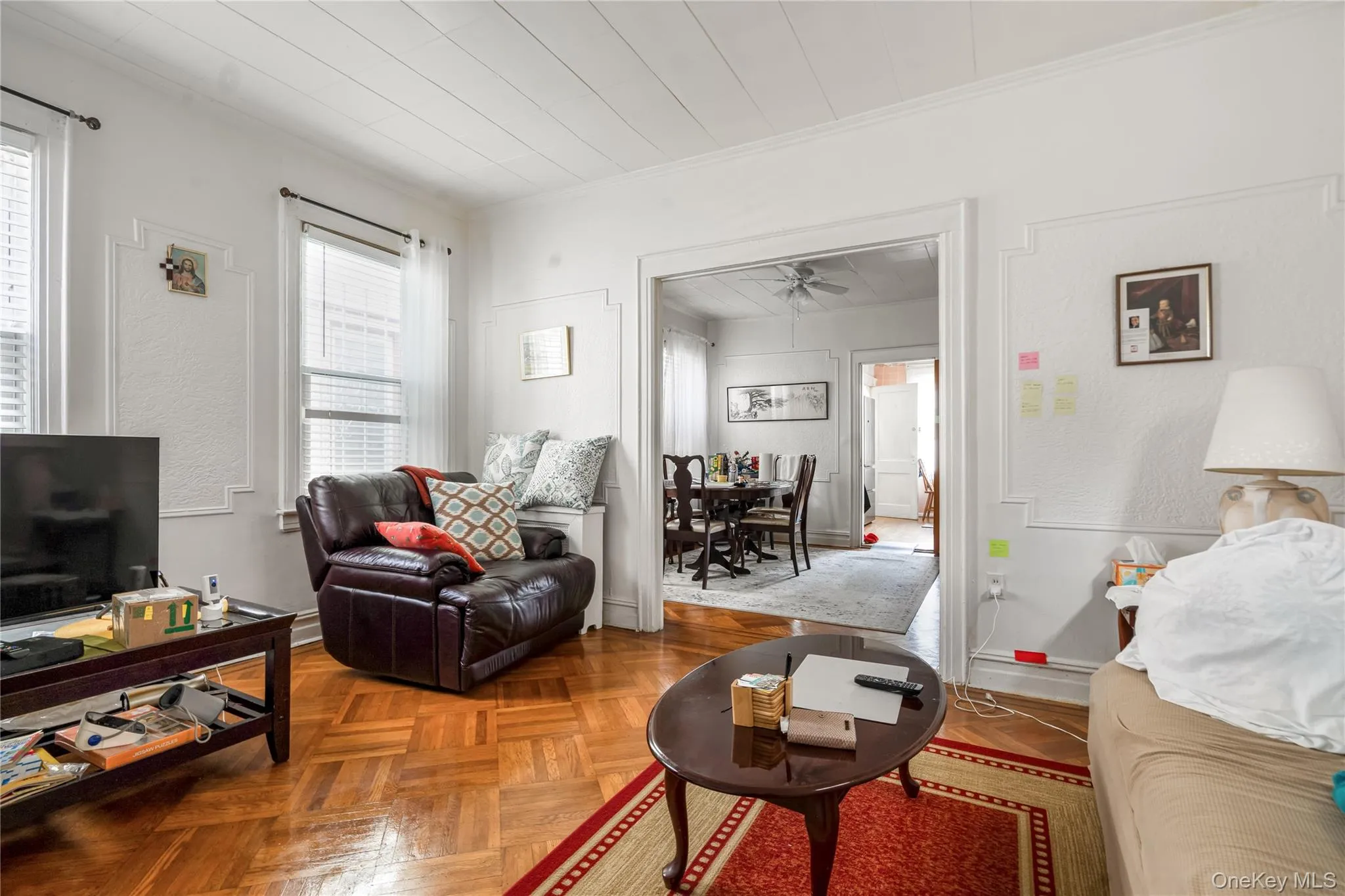 Living room featuring ornamental molding and baseboards Living room featuring ornamental molding and baseboards