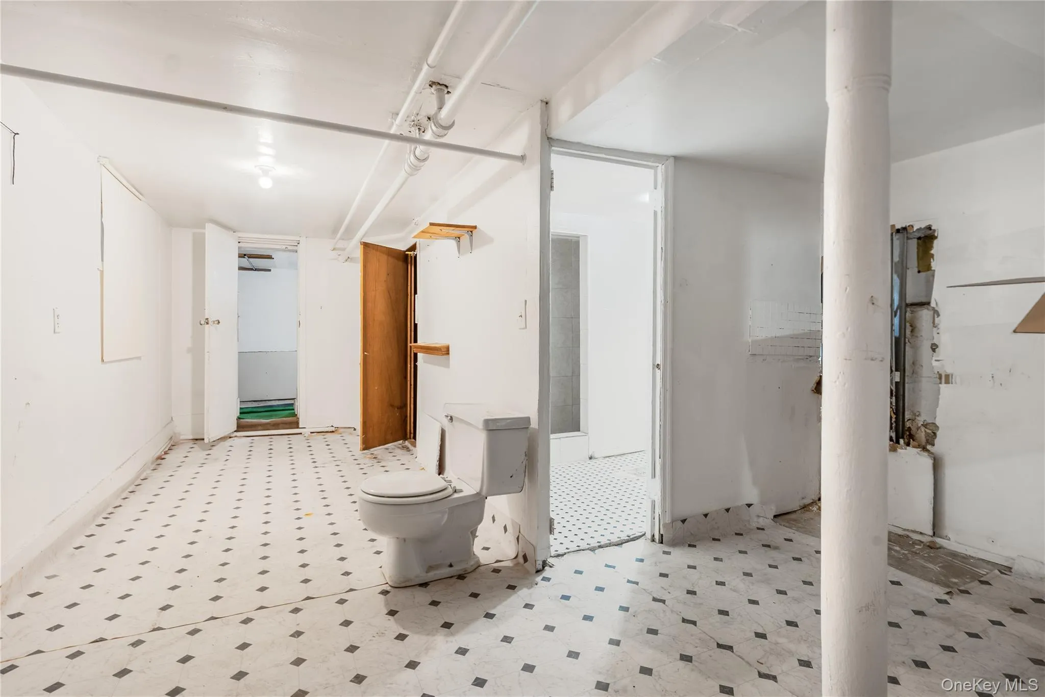 Bathroom featuring tile patterned floors and toilet Bathroom featuring tile patterned floors and toilet