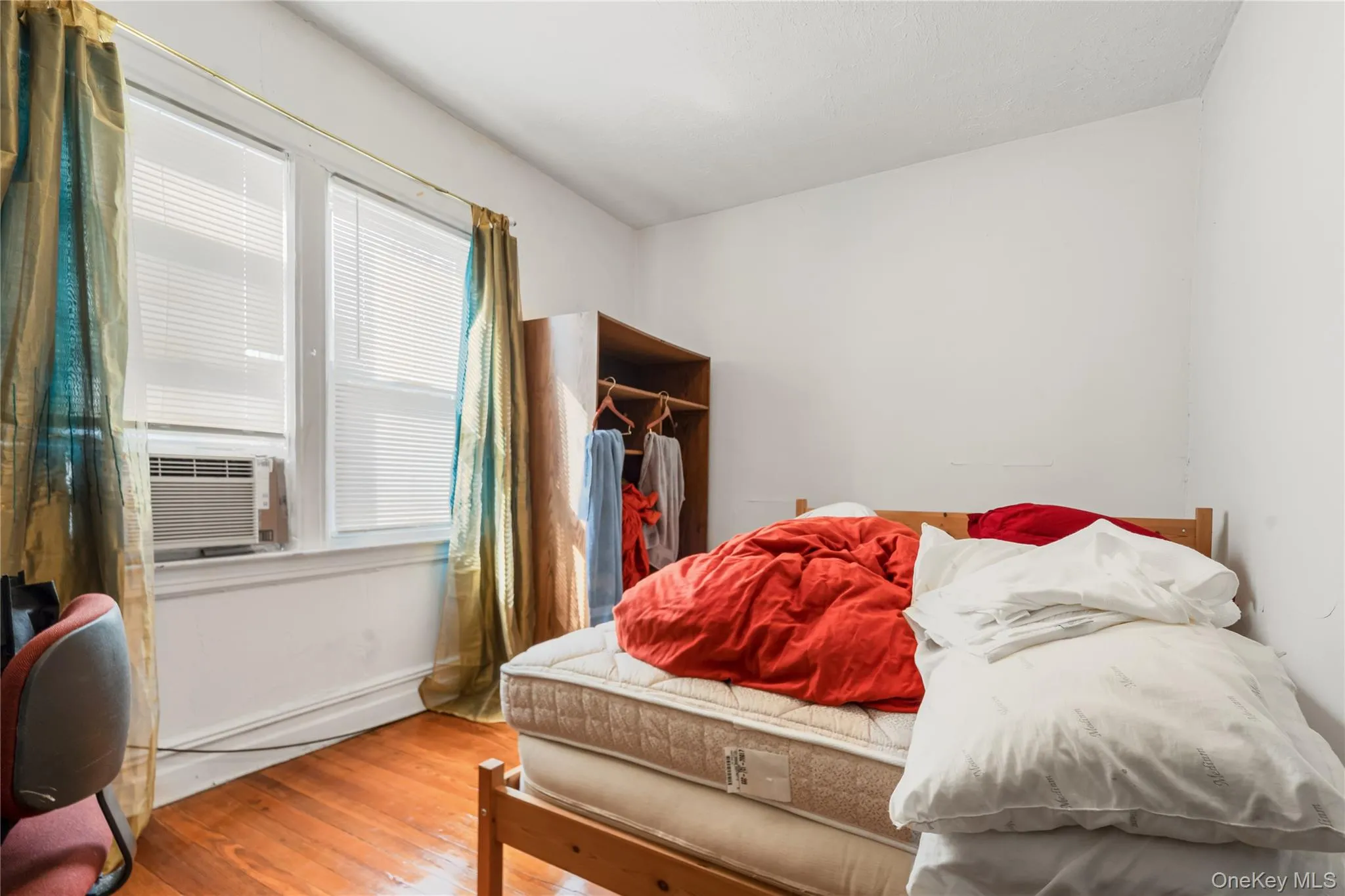 Bedroom featuring wood-type flooring and cooling unit Bedroom featuring wood-type flooring and cooling unit