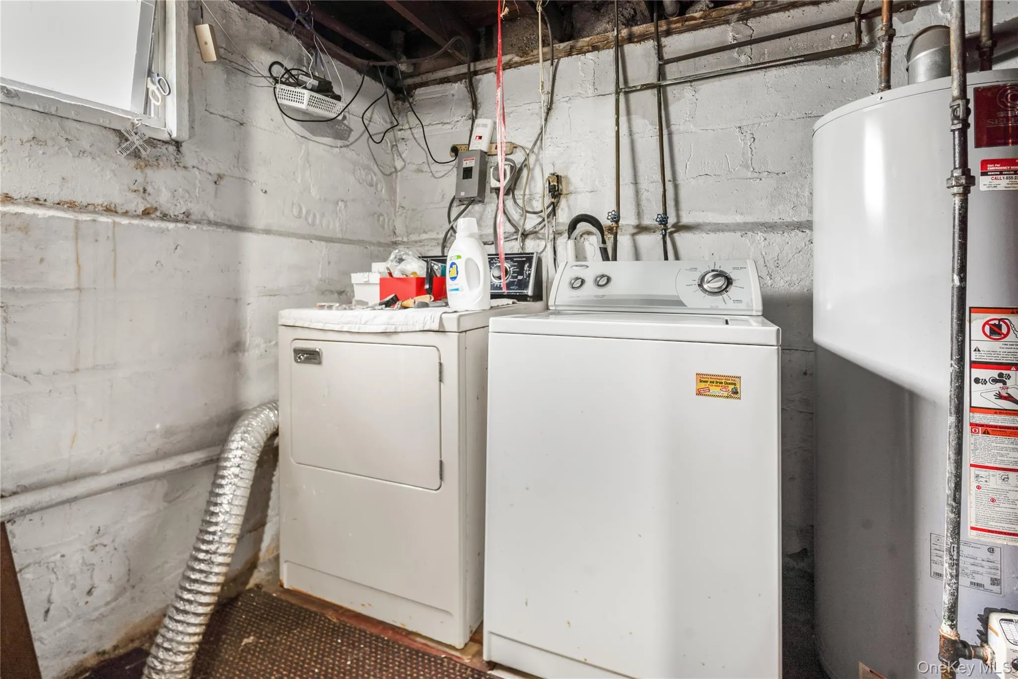 Laundry area with gas water heater and washer and dryer Laundry area with gas water heater and washer and dryer