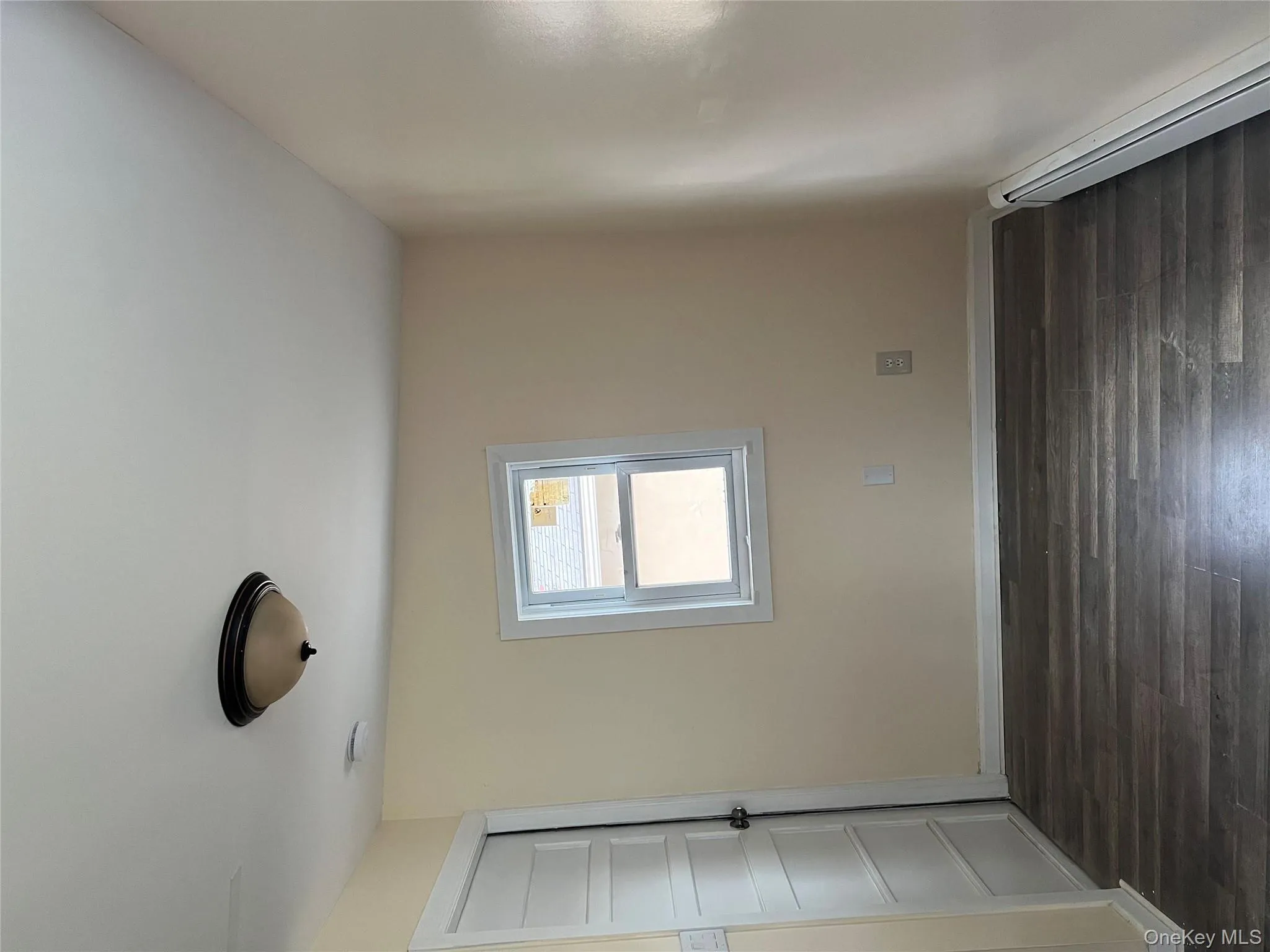 Spare room featuring a baseboard heating unit and dark wood-type flooring Spare room featuring a baseboard heating unit and dark wood-type flooring