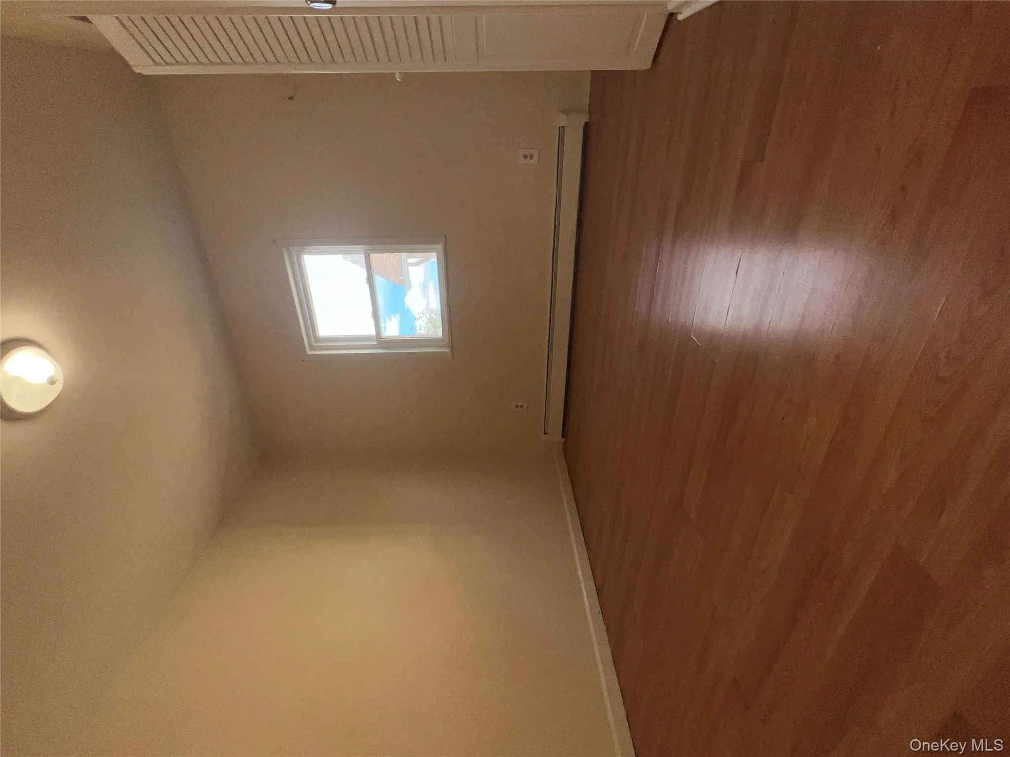 Unfurnished bedroom with dark wood-style flooring and a baseboard radiator Unfurnished bedroom with dark wood-style flooring and a baseboard radiator