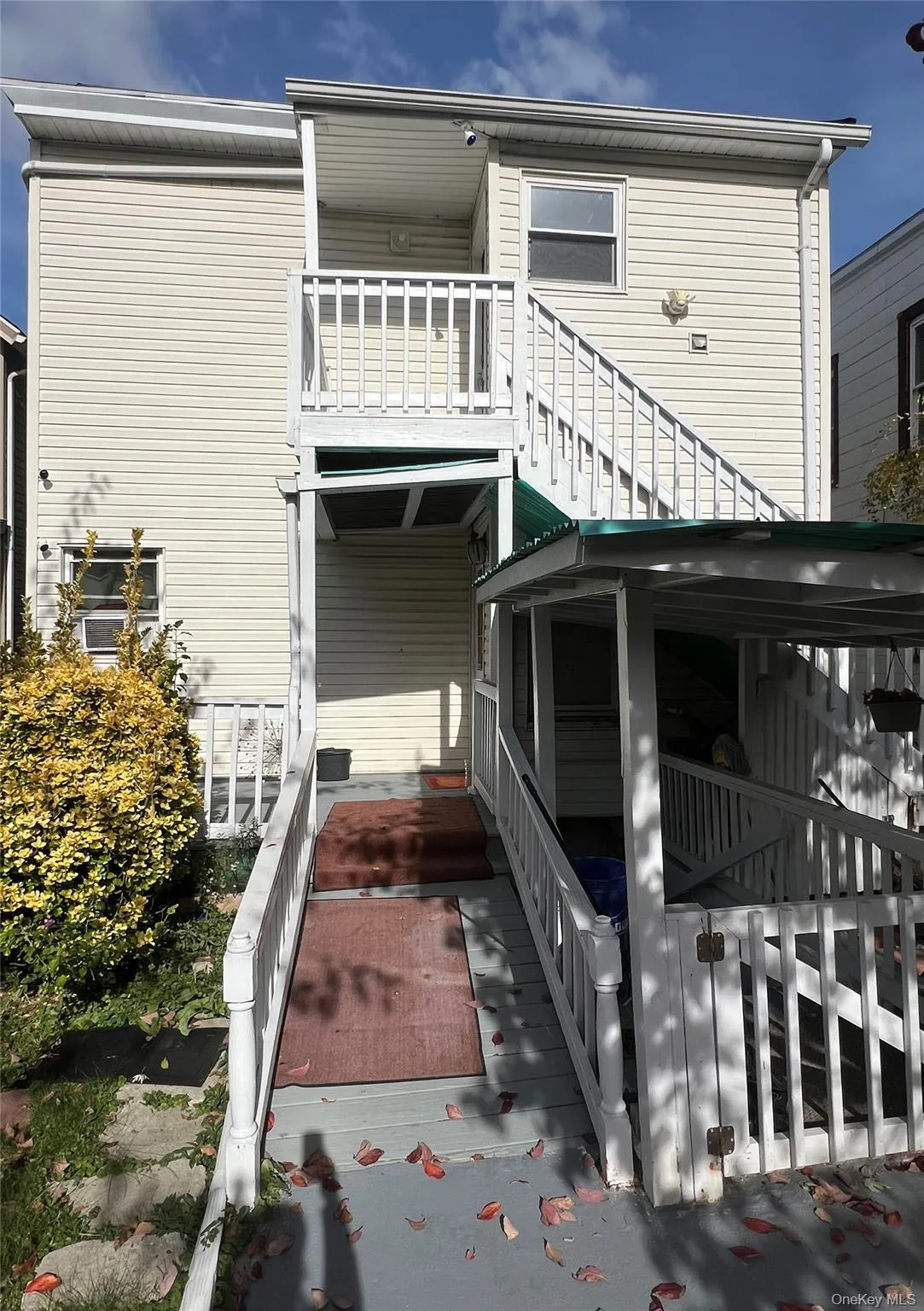 Rear view of property with a balcony and stairs Rear view of property with a balcony and stairs