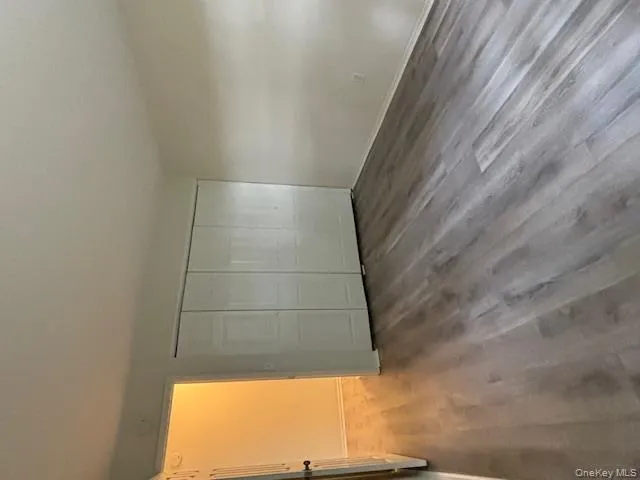 Unfurnished bedroom featuring dark wood-type flooring and a closet Unfurnished bedroom featuring dark wood-type flooring and a closet