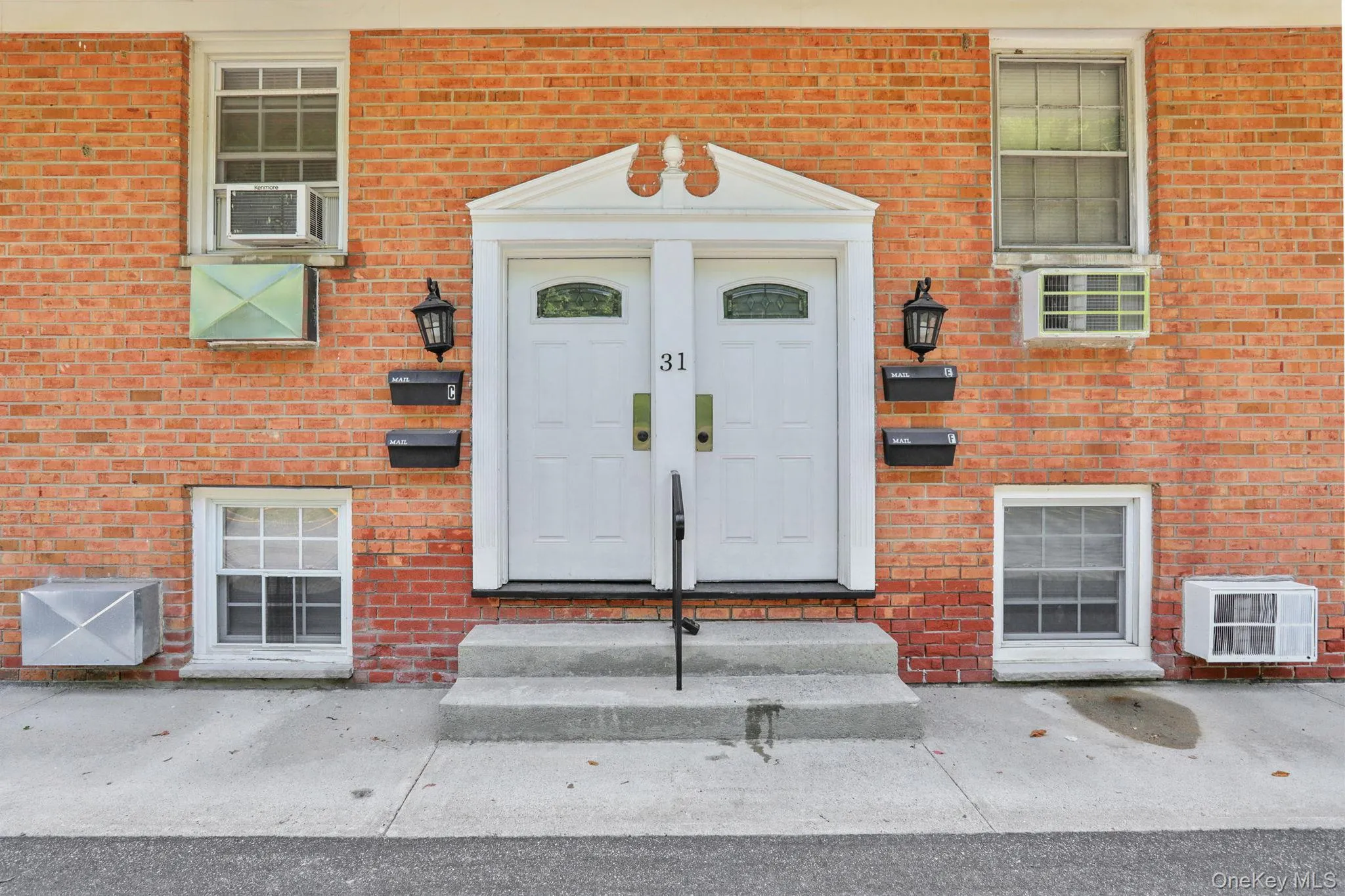 Property entrance featuring brick siding and a wall unit AC Property entrance featuring brick siding and a wall unit AC
