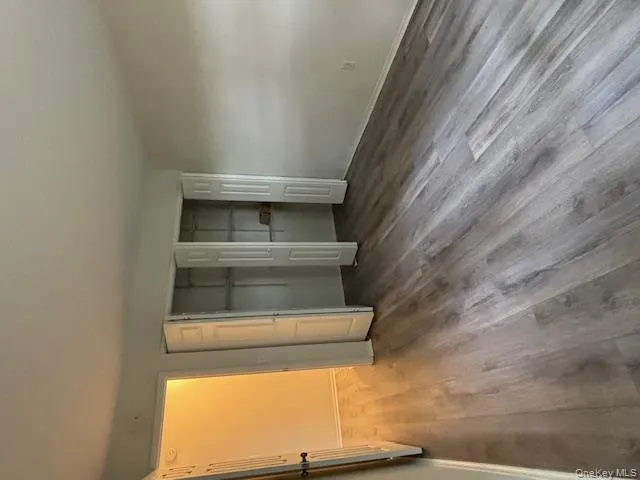 Unfurnished bedroom featuring two closets and wood finished floors Unfurnished bedroom featuring two closets and wood finished floors