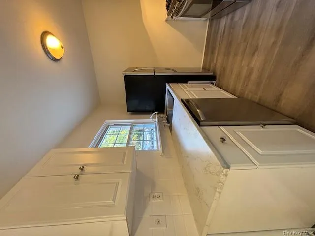 Kitchen featuring white cabinets, dark wood finished floors, white range, and dishwasher Kitchen featuring white cabinets, dark wood finished floors, white range, and dishwasher