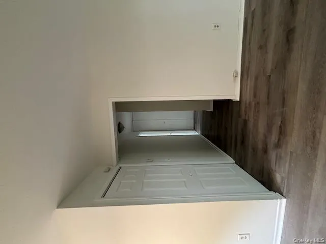 Unfurnished room featuring dark wood finished floors and baseboards Unfurnished room featuring dark wood finished floors and baseboards