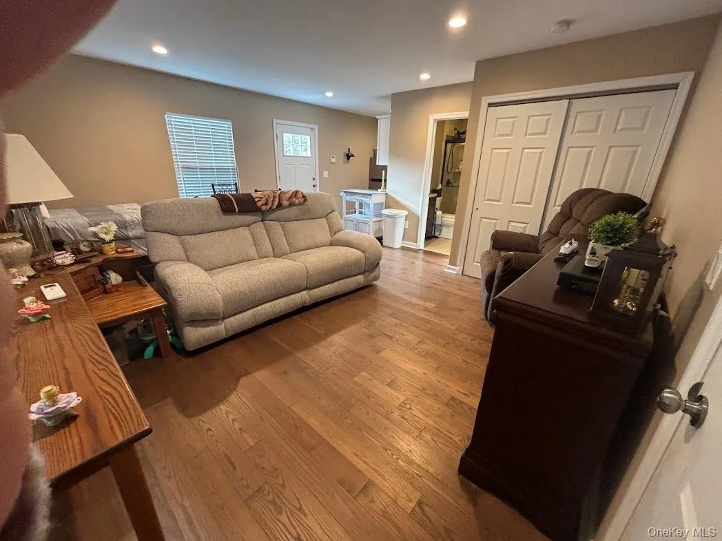 Living area featuring wood finished floors and recessed lighting Living area featuring wood finished floors and recessed lighting