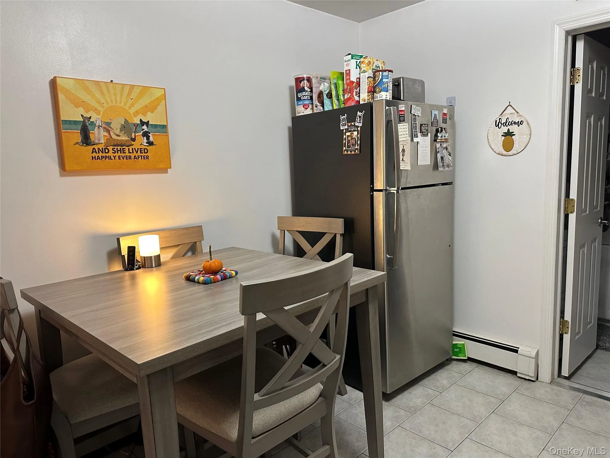 Dining space featuring baseboard heating and light tile patterned floors Dining space featuring baseboard heating and light tile patterned floors