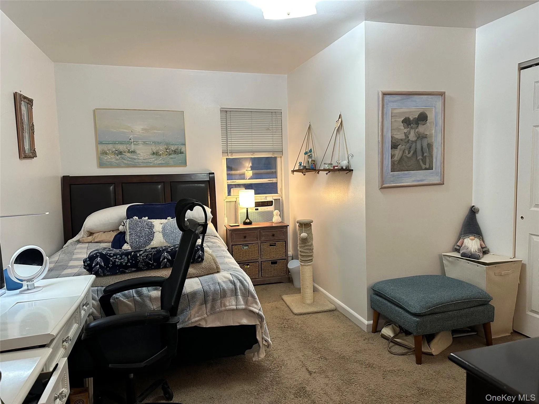 Bedroom with light colored carpet and baseboards Bedroom with light colored carpet and baseboards