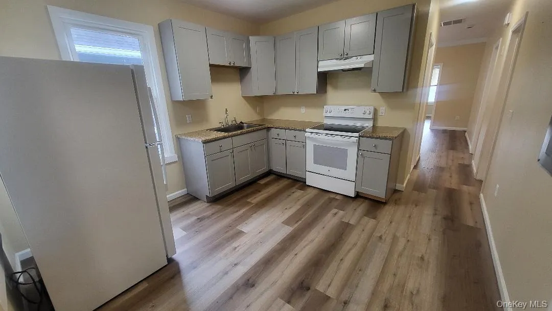 Kitchen featuring white appliances Kitchen featuring white appliances