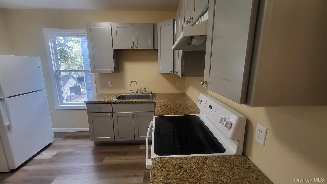 Kitchen has gray cabinetry Kitchen has gray cabinetry