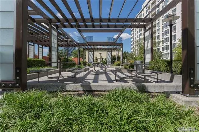 View of community with a patio area and a pergola View of community with a patio area and a pergola