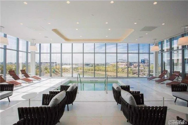 Lobby with expansive windows and recessed lighting Lobby with expansive windows and recessed lighting