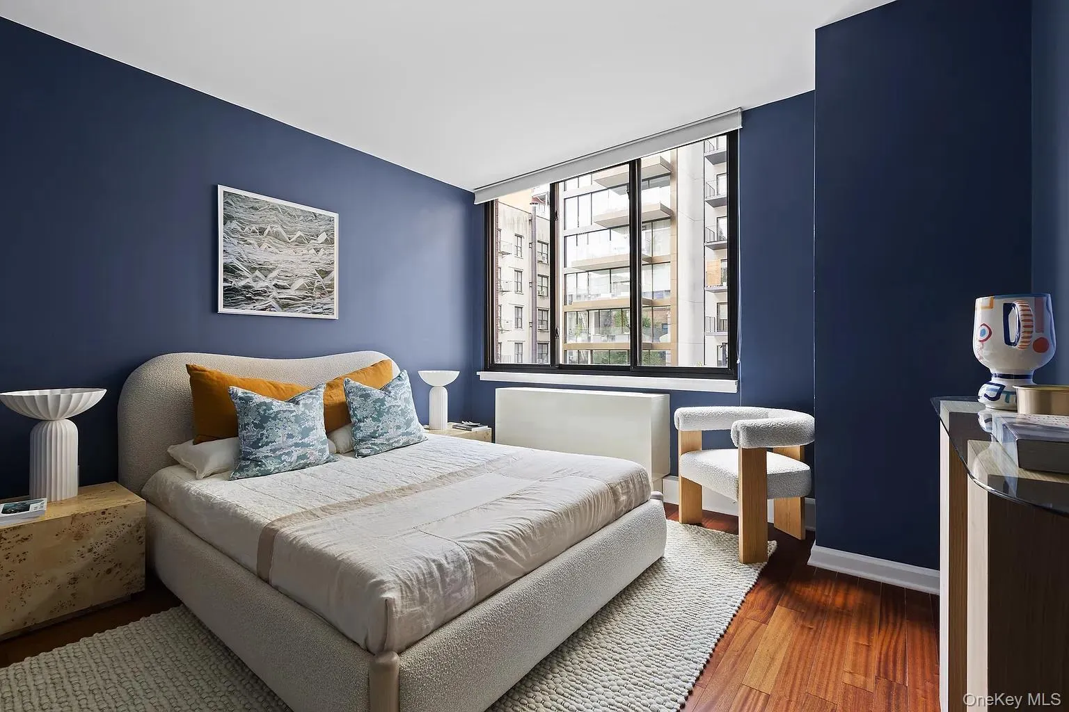 Bedroom featuring wood finished floors and baseboards Bedroom featuring wood finished floors and baseboards