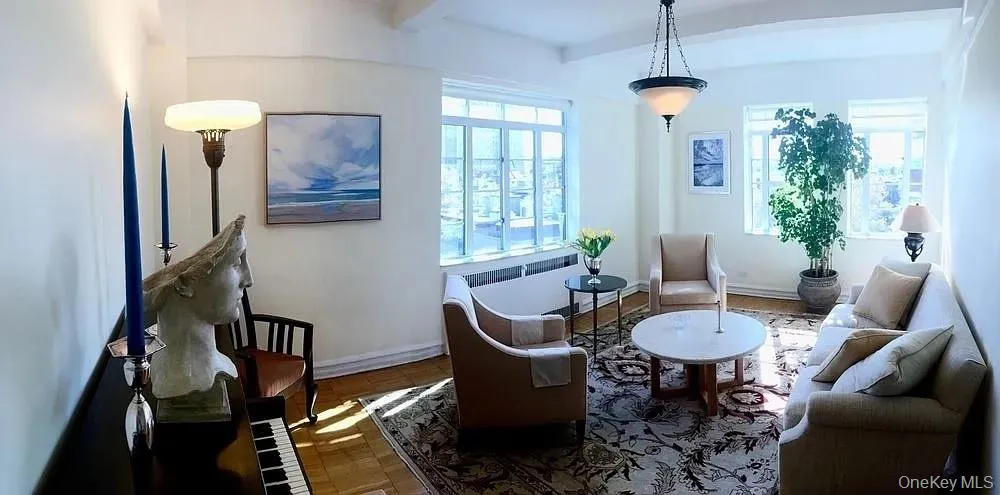 Living area with baseboards and beam ceiling Living area with baseboards and beam ceiling