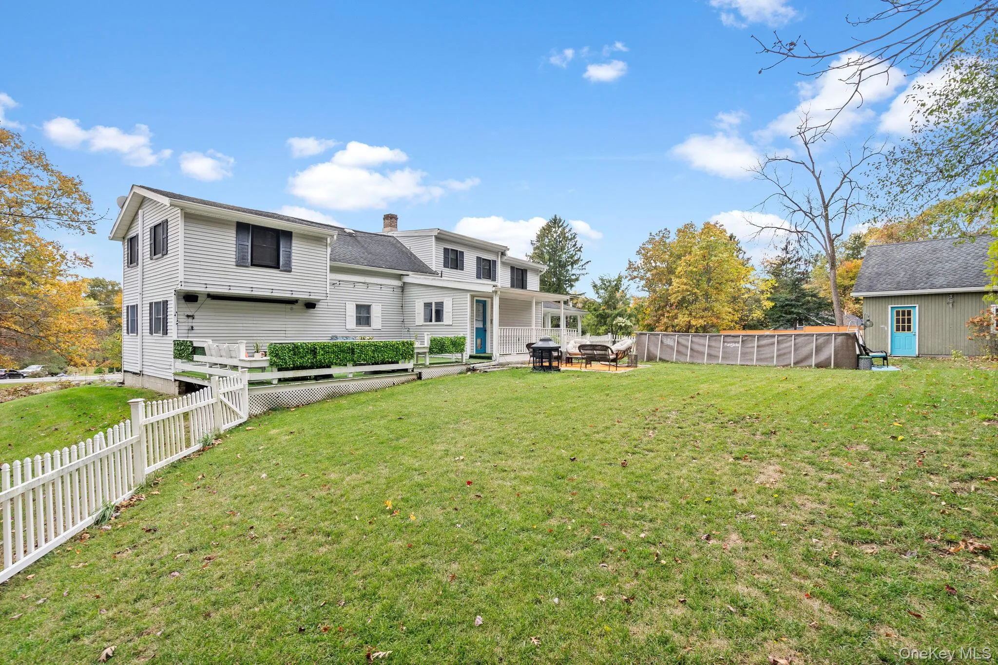 Rear view of house featuring a fenced backyard and a chimney Rear view of house featuring a fenced backyard and a chimney