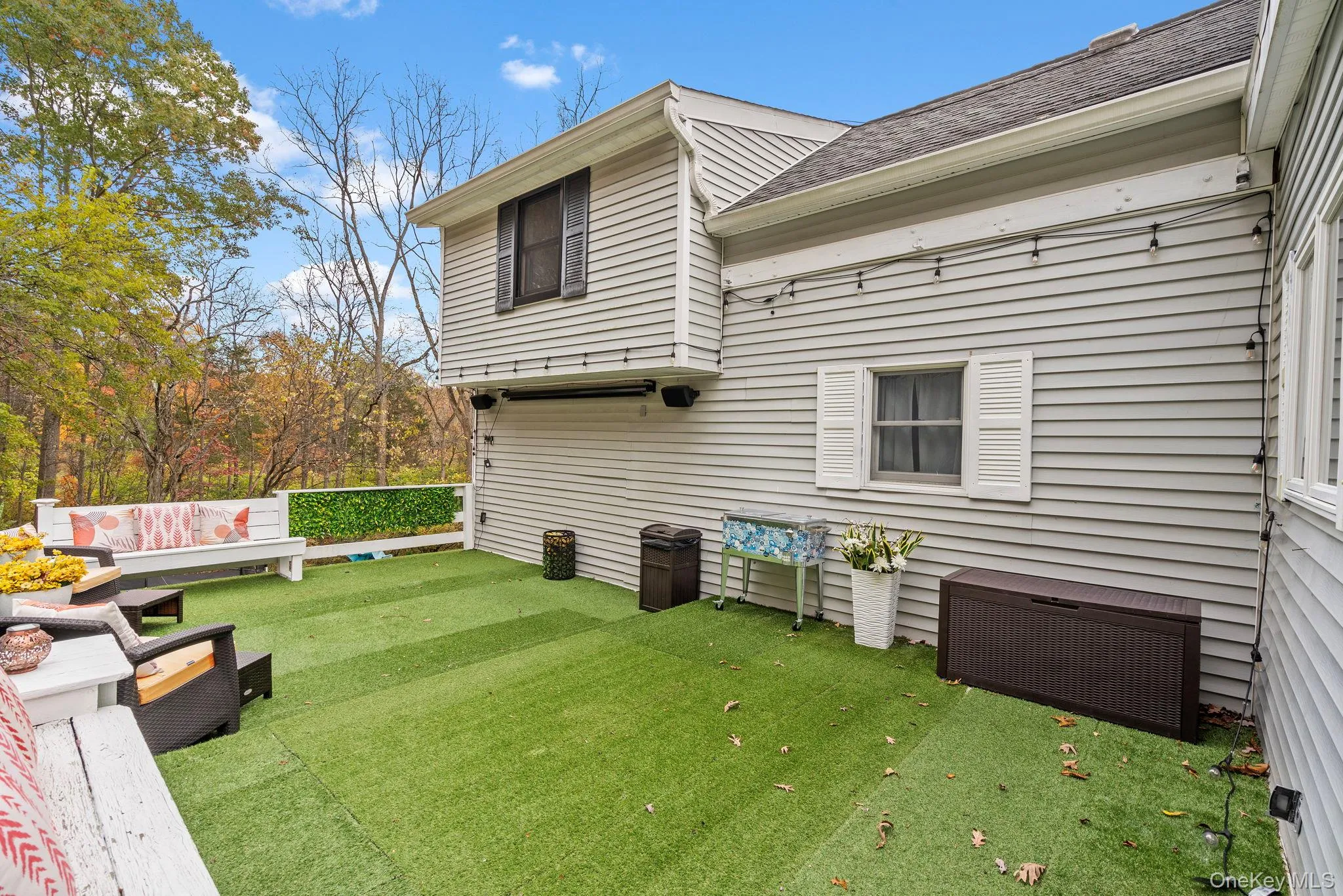 Rear view of property featuring a shingled roof and a lawn Rear view of property featuring a shingled roof and a lawn