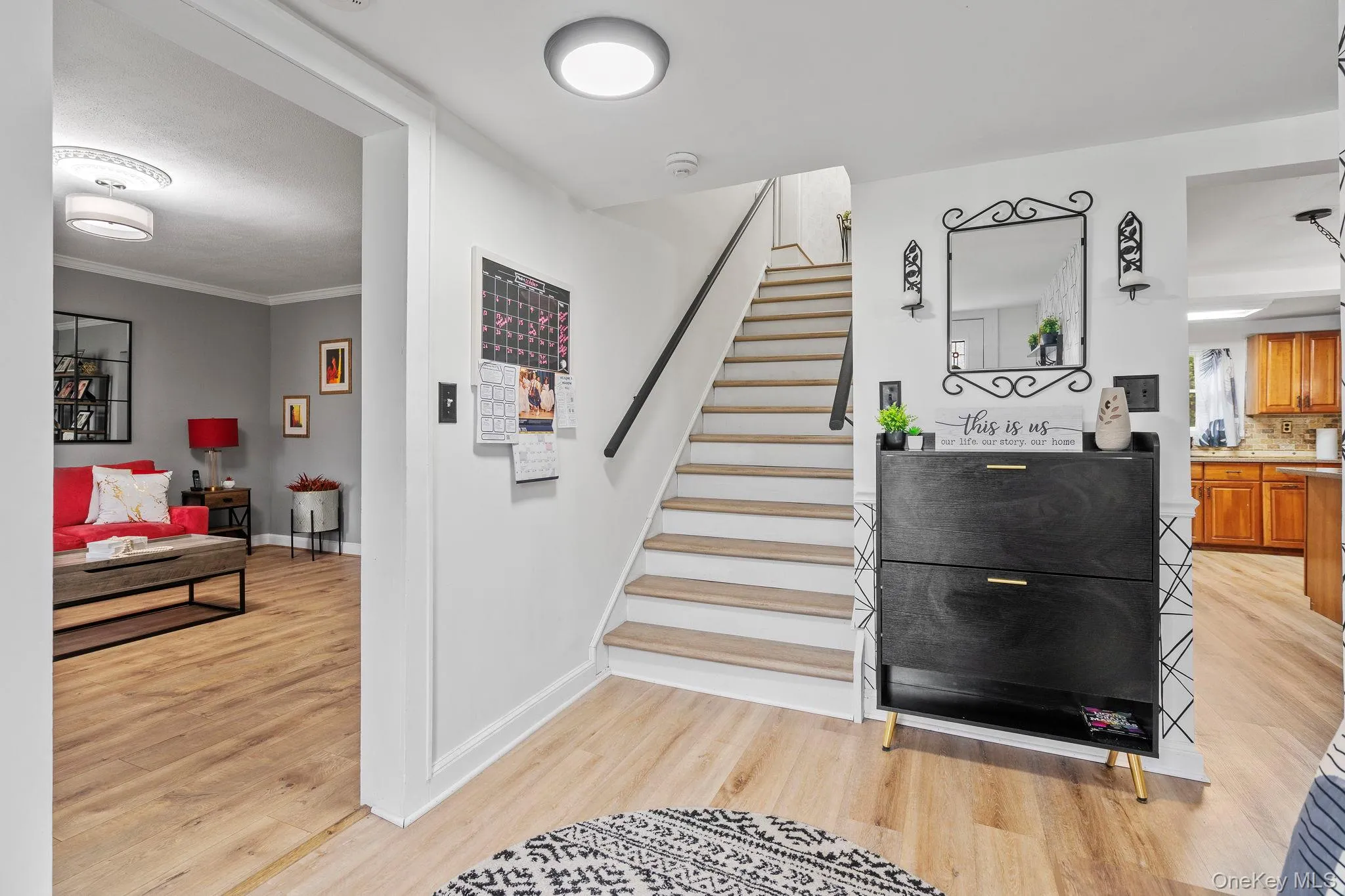 Stairs featuring wood finished floors and baseboards Stairs featuring wood finished floors and baseboards