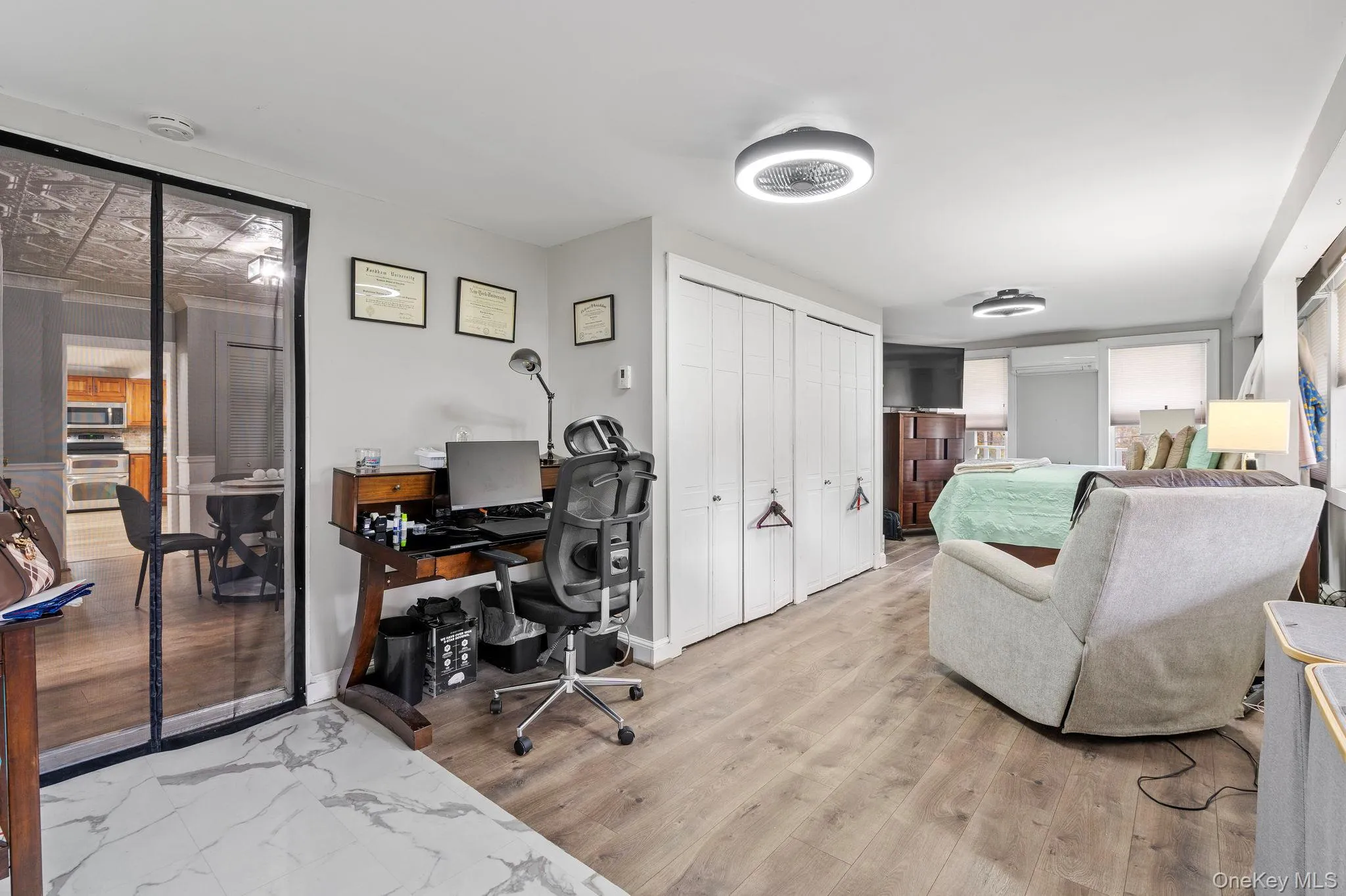 Office space featuring light wood-style flooring and a wall mounted AC Office space featuring light wood-style flooring and a wall mounted AC