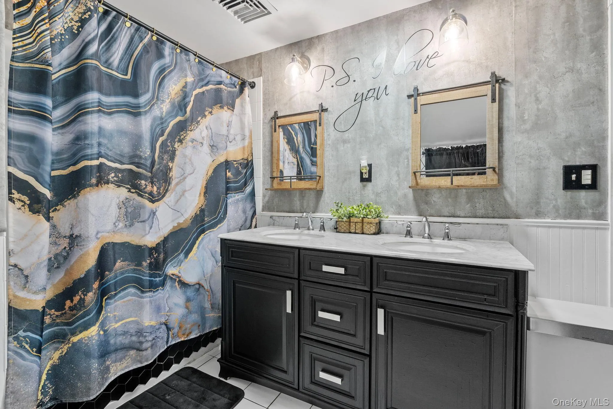 Bathroom with curtained shower, light tile patterned floors, and double vanity Bathroom with curtained shower, light tile patterned floors, and double vanity