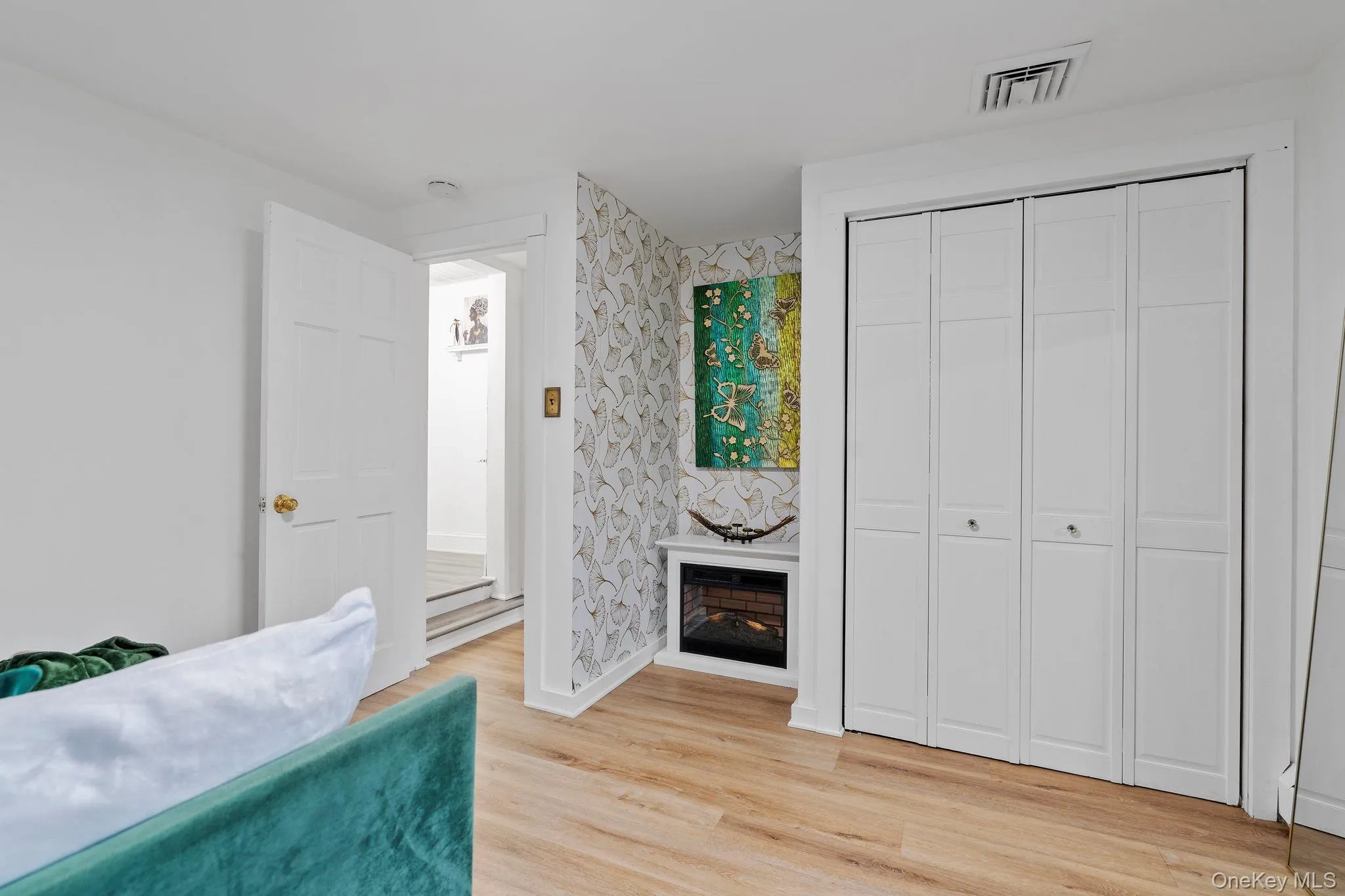 Bedroom with a closet and light wood-style flooring Bedroom with a closet and light wood-style flooring