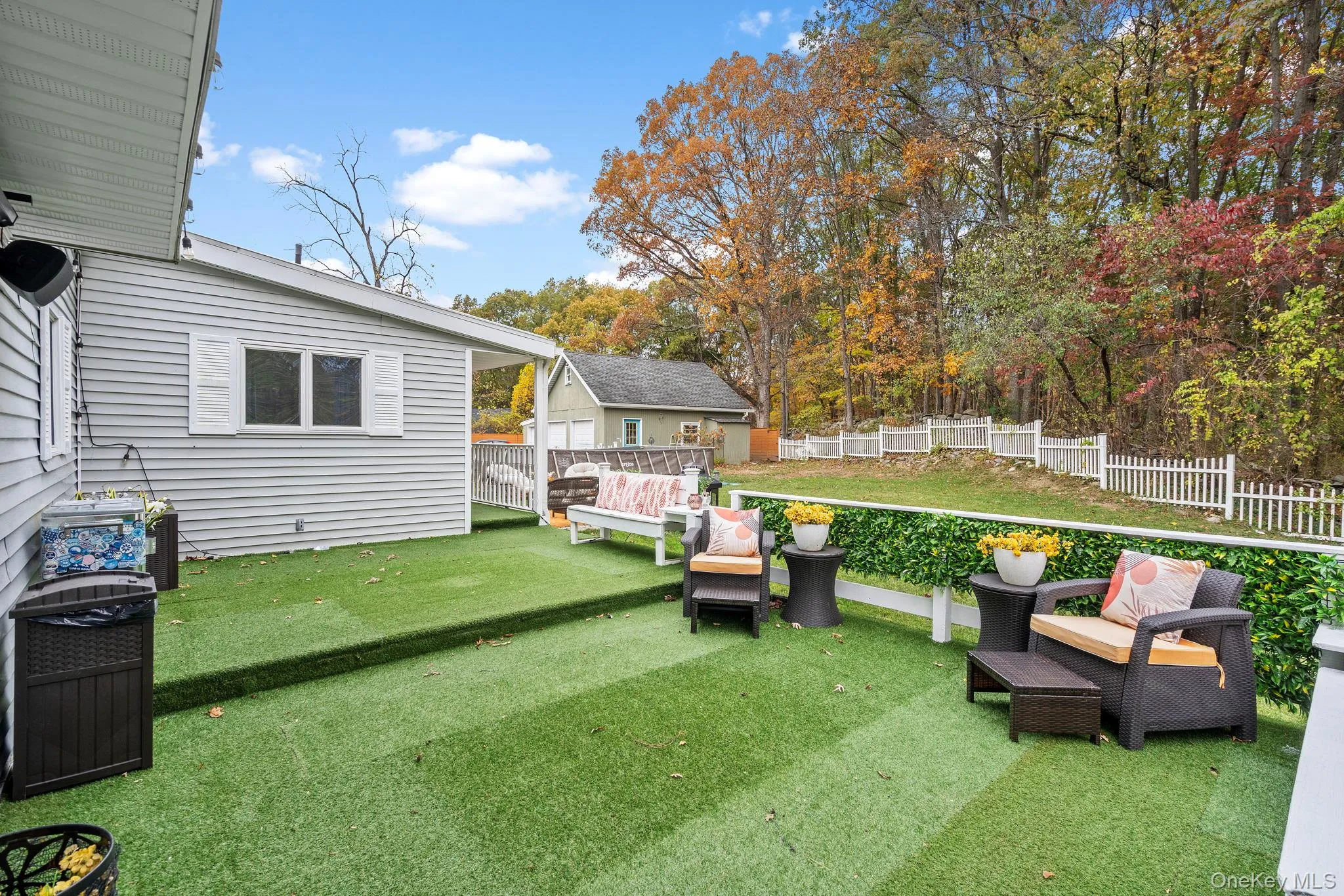Fenced backyard with a deck and an outdoor structure Fenced backyard with a deck and an outdoor structure