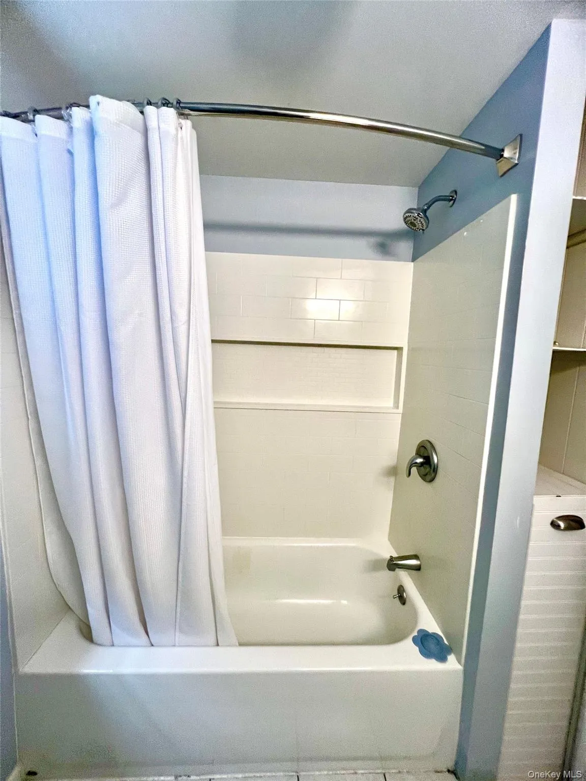 Bathroom featuring shower / tub combo with curtain Bathroom featuring shower / tub combo with curtain