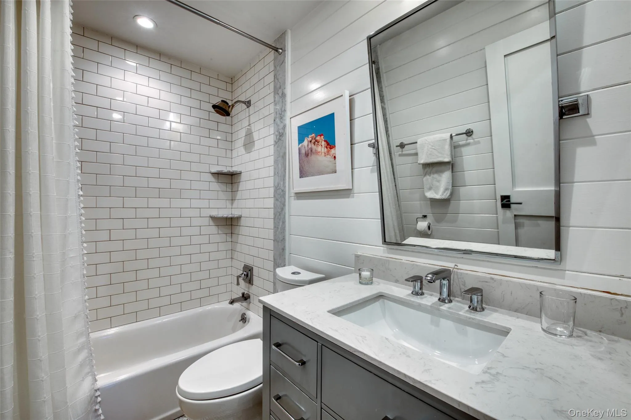 Full bathroom with shower / bath combination with curtain and vanity Full bathroom with shower / bath combination with curtain and vanity