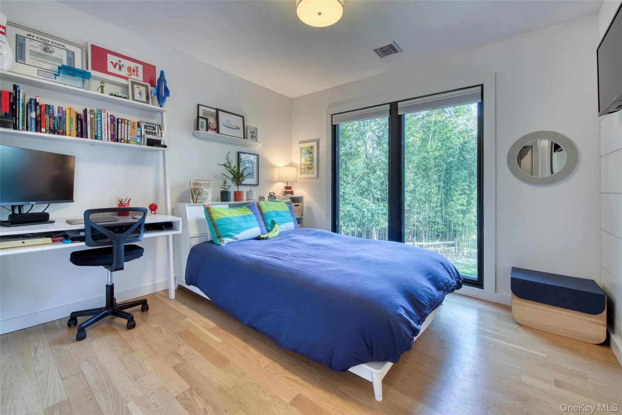 Bedroom featuring a desk, light wood-style floors, and access to exterior Bedroom featuring a desk, light wood-style floors, and access to exterior