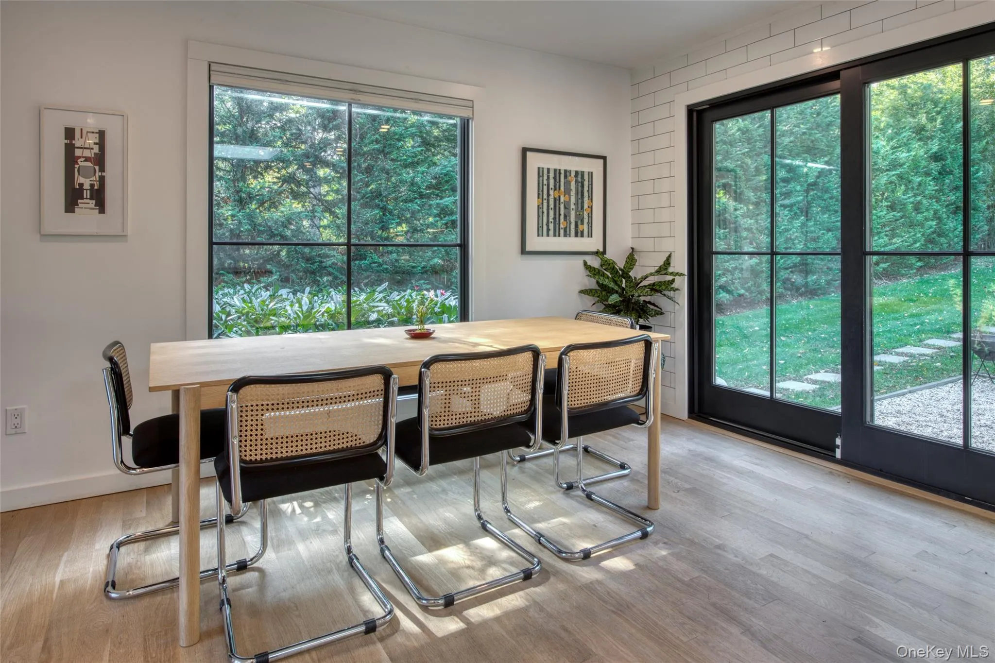 Dining space with healthy amount of natural light and light wood-style flooring Dining space with healthy amount of natural light and light wood-style flooring