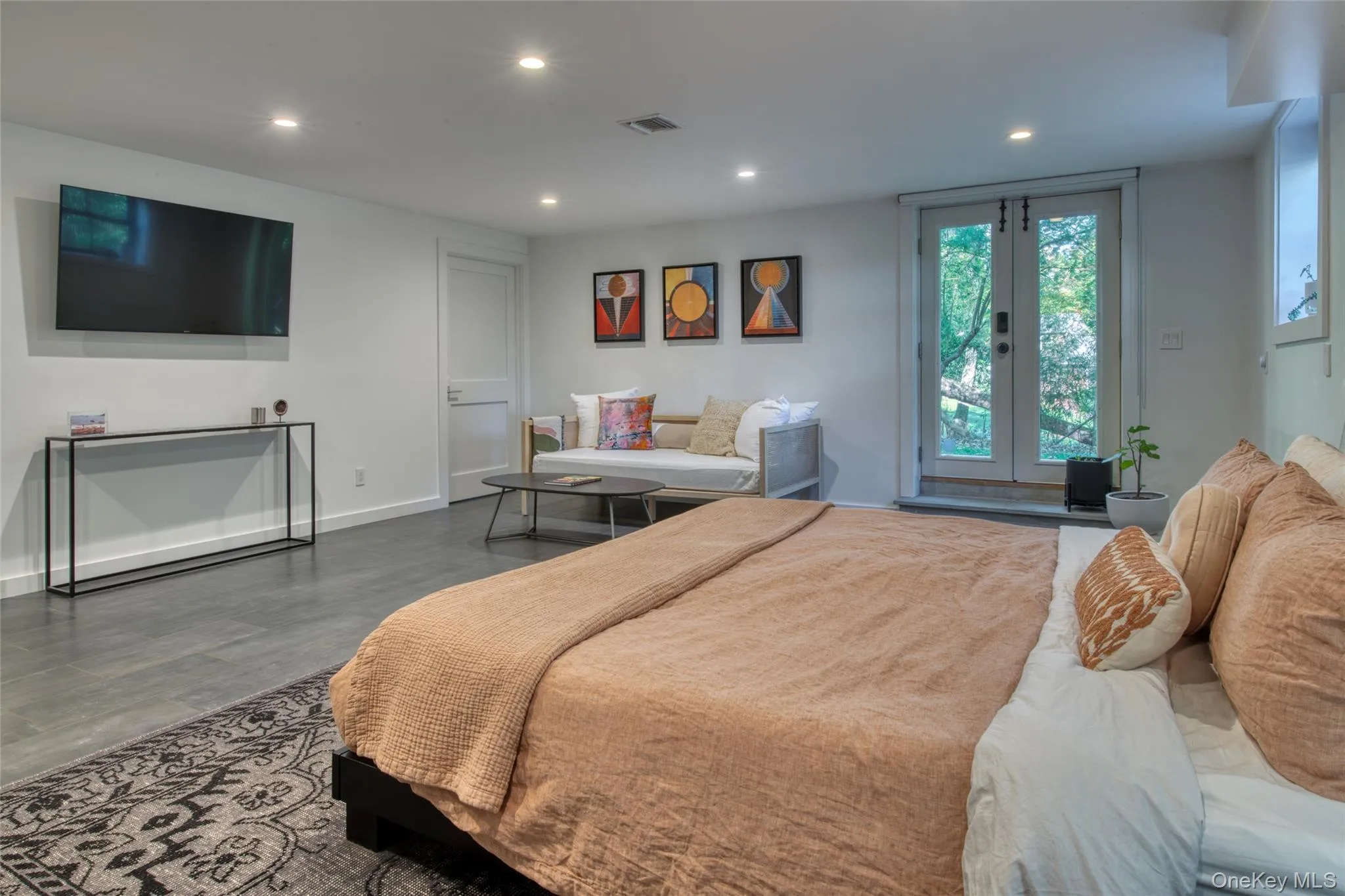 Bedroom with recessed lighting, access to exterior, french doors, and wood finished floors Bedroom with recessed lighting, access to exterior, french doors, and wood finished floors